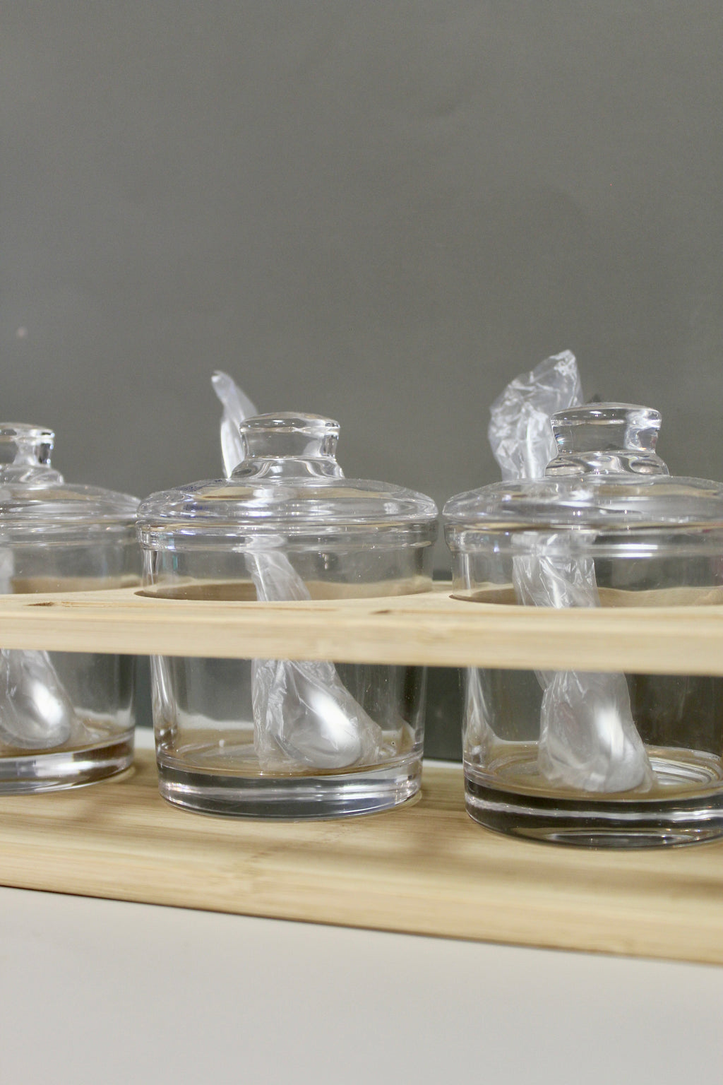 Glass Jam Set with 3 Glass Jars and Spoons On A Wood Stand