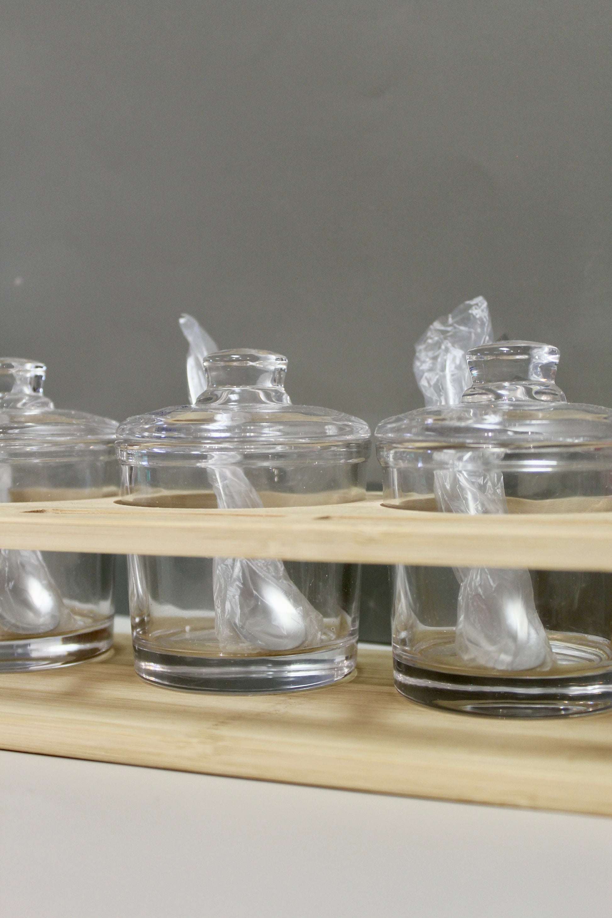 Glass Jam Set with 3 Glass Jars and Spoons On A Wood Stand